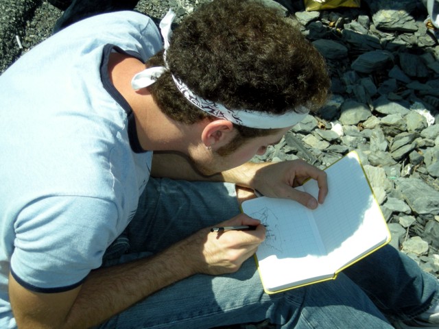 student drawing in the field